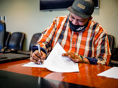 Ronald Dixon signing loan paperwork