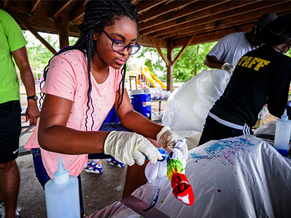 girl painting during summer camp