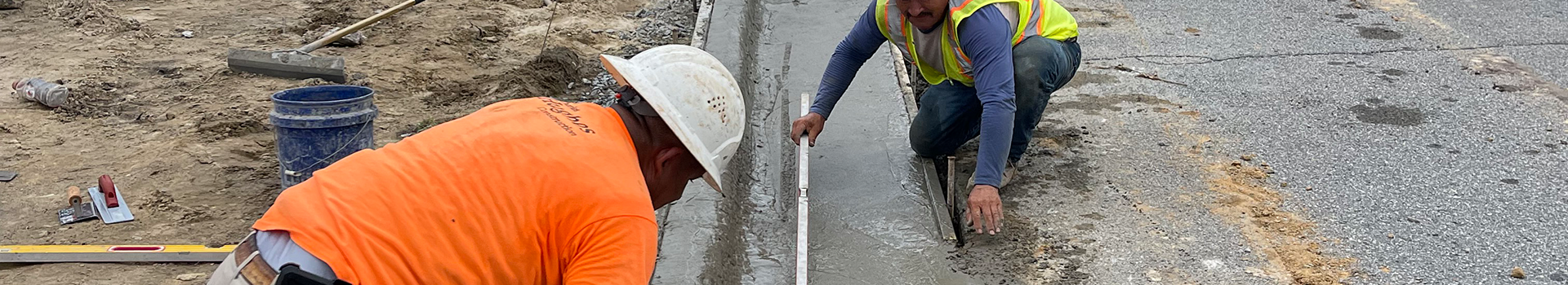 Workers working on a curb