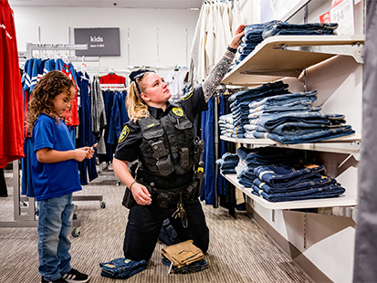 police officer looking at pants with a child