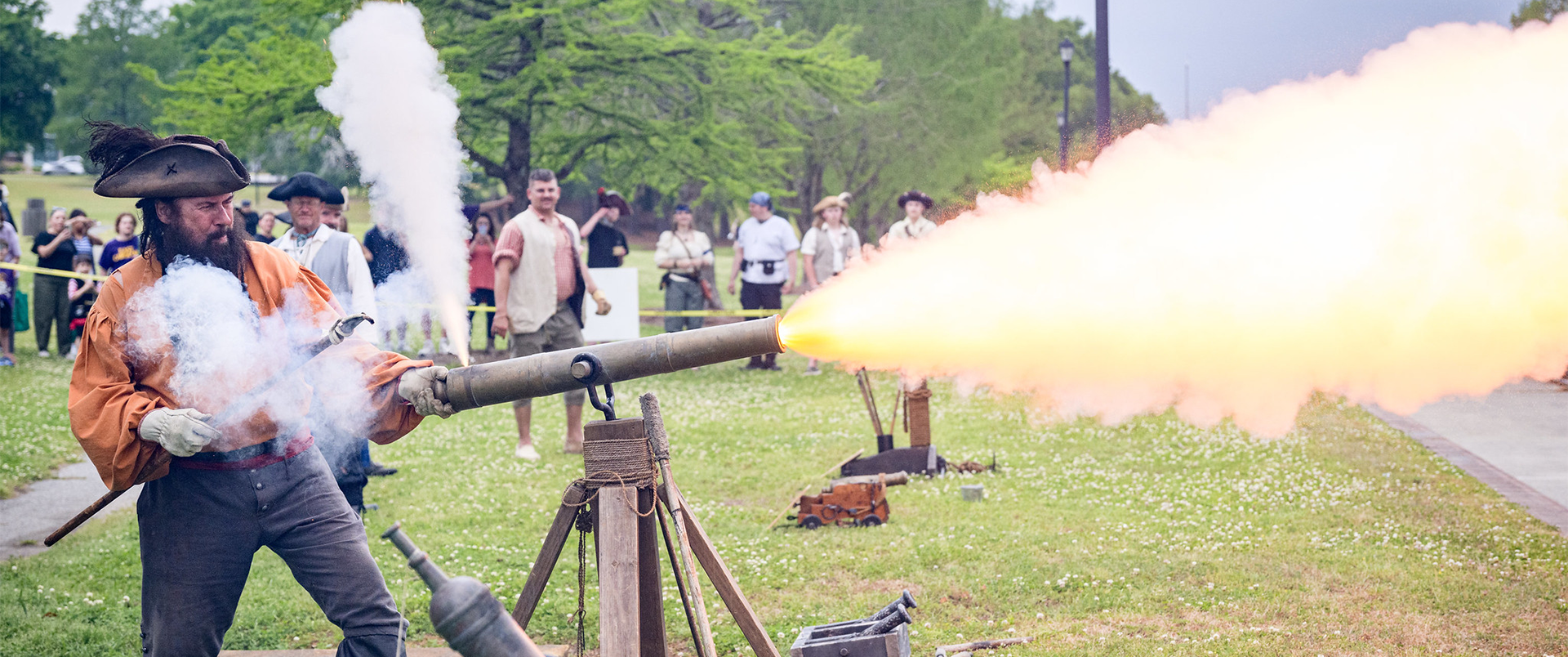 Pirate firing a cannon on Town Common during PirateFest