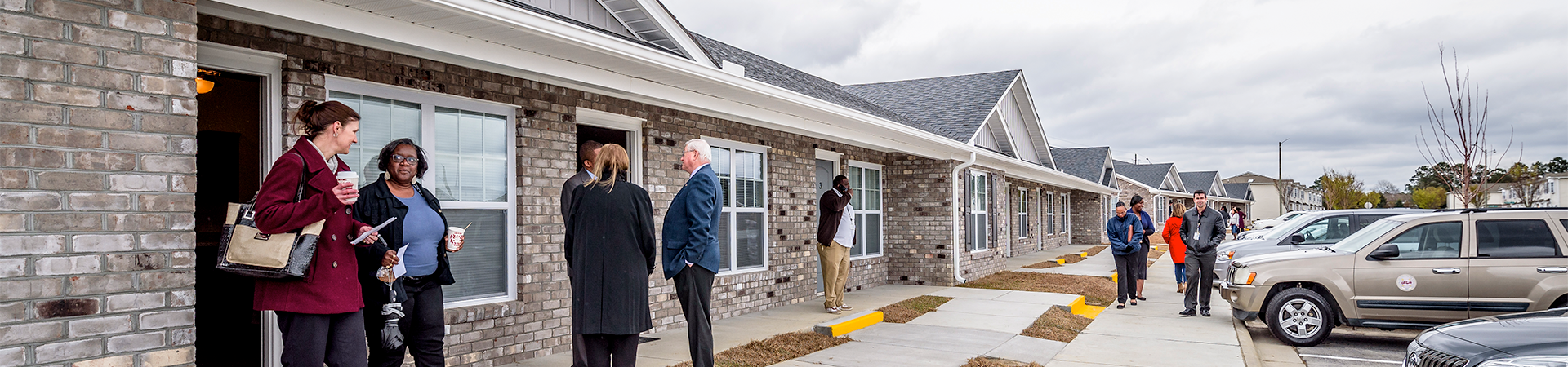 People talking at the Honor Ridge housing ribbon cutting