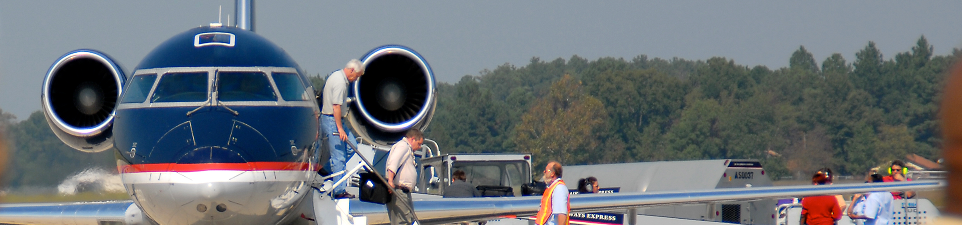 Men getting off plane at airport